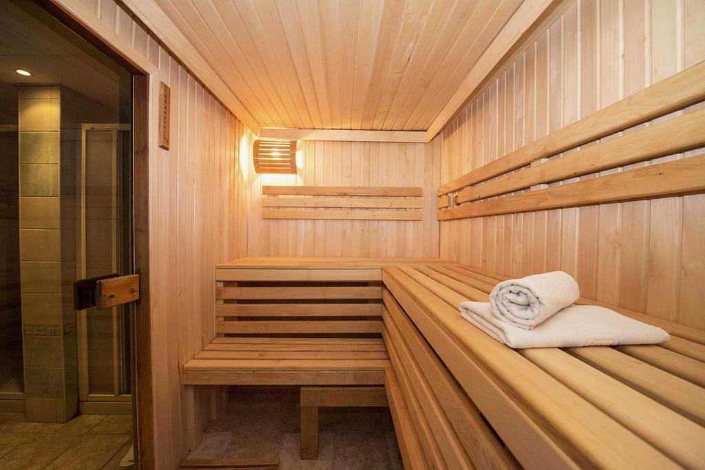 Stylish boutique hotel room with green decor and large bed